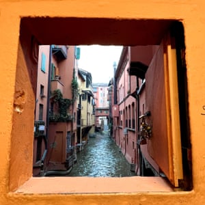The famous secret doorway to the hidden canals of Bologna, Italy. Taken on a wintery afternoon in the early days of 2023 while exploring this beautiful historic city. The hatch is weighed down in padlocks symbolising eternal love from couples all over the world.