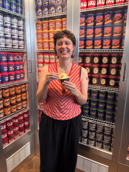 Lucy Knight in front of a stand up freezer filled with different ice-cream flavours