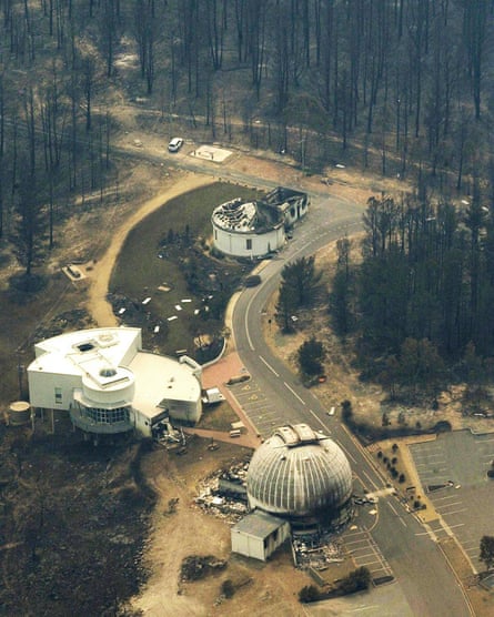 Aerial view of the fire-damaged observatory surrounded by burnt bush
