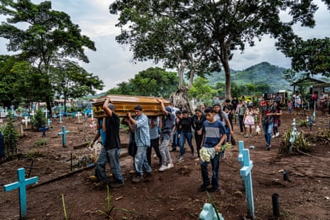 A funeral delegation carry the coffin of Douglas Rivera, a 22-year-old leader of MS-13, in Chapeltique municipal cemetery