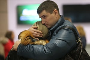 People comfort each other at Pulkovo airport.