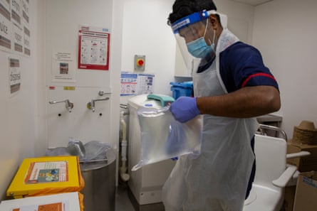 In his final job of the shift, Sebastian, empties effluent bags from patients with renal failure. ‘As a senior nurse I could not offer to do this as I’m just going home, but we have an emotional and moral commitment to each other. We all worked through the pandemic together and I can’t look then in the face and say “you do it”. We laugh and cry together.’