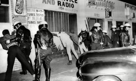Police search African American youths during the Watts riots