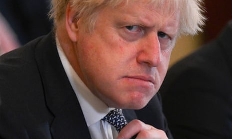 Boris Johnson adjusts his tie at the start of a cabinet meeting at No 10 in May 2022