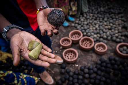 A charcaol ball and soap held out in someone’s hands