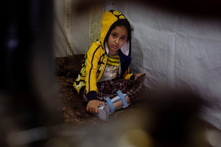Nada, who is eight years old and no longer able to walk, sits in her family shelter in Zahlé, Lebanon, 25 March 2021