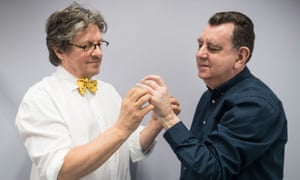 King has his hands examined by Prof Simon Kay, the surgeon who performed the transplant.