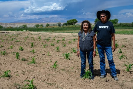 Bertha and Allen Etsitty, on their farm near Shiprock, with the Carrizo mountains in the background.