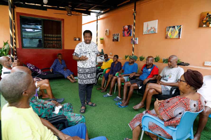 Art teacher Kunle Adewale, centre, started researching social therapies for older people after his stepmother experienced memory loss following a stroke.