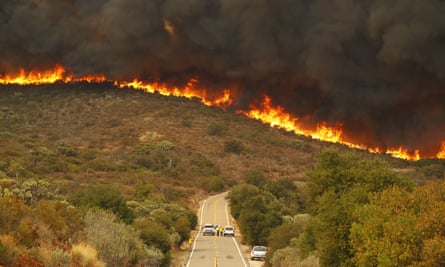 San Diego Sheriffs and CDF firefighters stage on Lyons Valley Road during the Valley Fire on Sunday