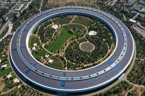 A large, futuristic, and completely circular modern building resembling a flying saucer, enclosing its own extensive grounds, seen from the air