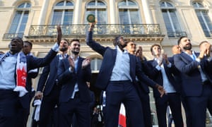 Paul Pogba holds the World Cup trophy aloft during an official reception at the Ãlysée Palace