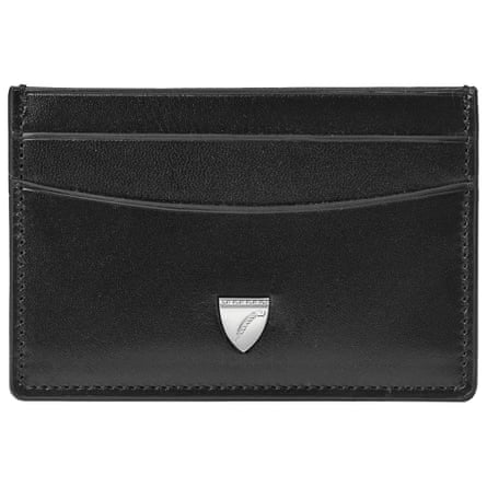 A black three pocket leather card holder. There is a silver enamel Aspinal logo at the bottom in the centre. It is on a white background.