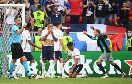 Hungary’s Peter Gulacsi celebrates at the final whistle as France’s Raphael Varane and Corentin Tolisso look on.