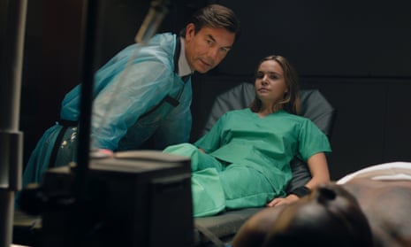 Jerry O’Connell leans over Bailee Madison, who is in a surgical gown, in Play Dead