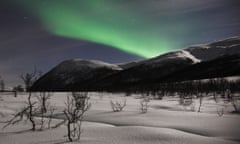 Aurora borealis over snowy landscape, Norway, Tromso, Oldervik.