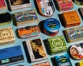 collection of several colorful tinned fish containers against light blue background