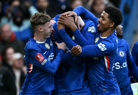 Tosin’s headis rubbed by teammates as they celebrate