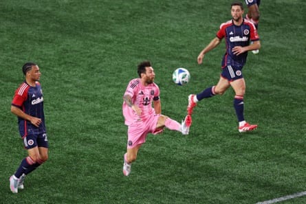 Lionel Messi controls the ball mid-air against New England Revolution defenders at Gillette Stadium