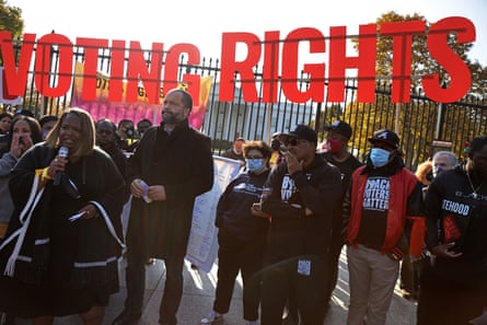 people gathered under sign that says 'voting rights'