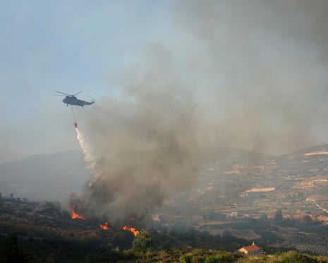 A British helicopter drops water over Omodos village, Cyprus.