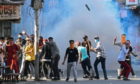 Protesters take part in a demonstration amid teargas smoke fired by Indian security forces in Srinagar in May 2022