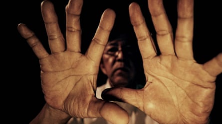 A closeup of master restorer Koji Mayuyama’s hands, palms facing camera