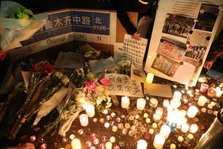 A candlelight memorial for those who died following a fire in a highrise building in Urumqi.