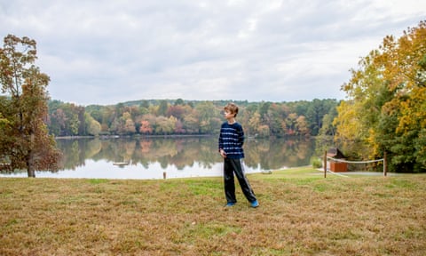 Graham, a boy on the autism spectrum, photographed beside a lake by his mother in 2015