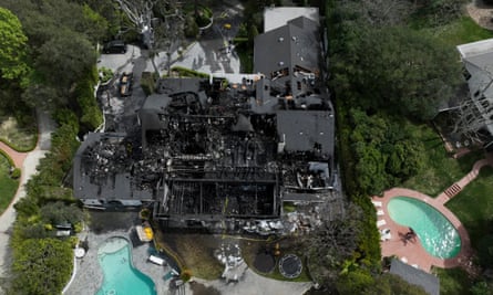An aerial view of the footprint of a very large house that is completely gray, with two aqua- pools beside it.