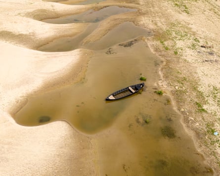 Aerial view of a boat stranded in shallow pools on the Danube's dried riverbed