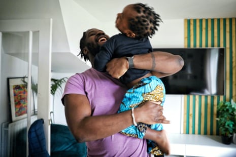 Richard Odufisan plays with his son