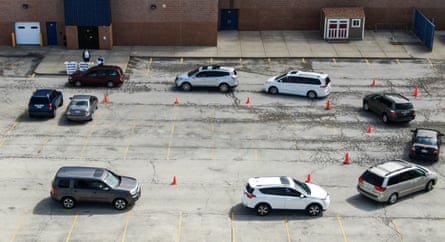 A queue of vehicles lining up to receive iPads and Chromebook laptops for students to use in remote learning at Indian Hills Elementary School in Round Lake Heights, Illinois, in April last year.