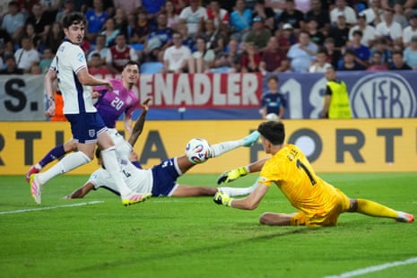 England goalkeeper James Beadle dives and saves a shot from Germany’s Paul Nebel.
