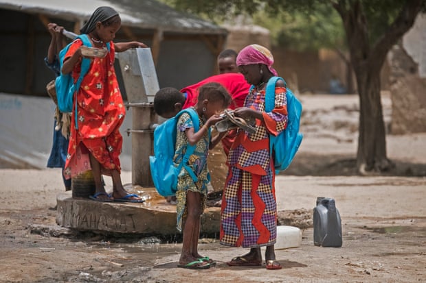 Children ho were forced to flee their homes because of the Boko Haram insurgency drink water in a school yard in Bol, in Chad’s Lake region