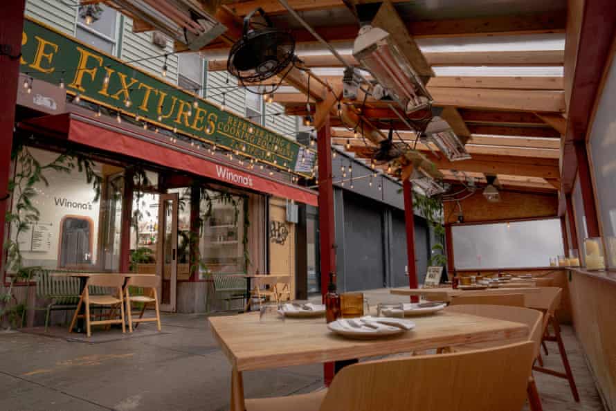 View of an outdoor dining area with heat lamps above