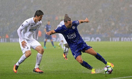 Danny Drinkwater and Ki Sung-yueng battle for the ball as the rain comes down late in the game.