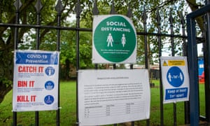 Physical distancing signs and a notice about staggered start and finish times at the Dedworth middle school in Windsor.