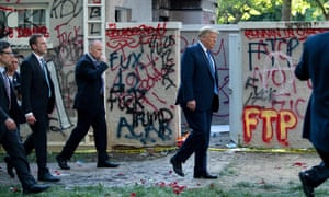 Donald Trump walks back to the White House escorted by the Secret Service after appearing outside St John’s Episcopal church on Monday.