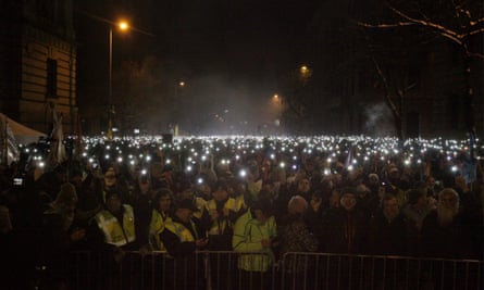 Protesters against the ‘slave law’ light their mobile phones in front of the parliament building in Budapest