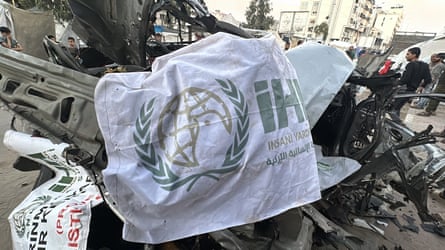 The mangled metal of a car blown up in an attack, with tarpaulins thrown over, presumably to cover corpses