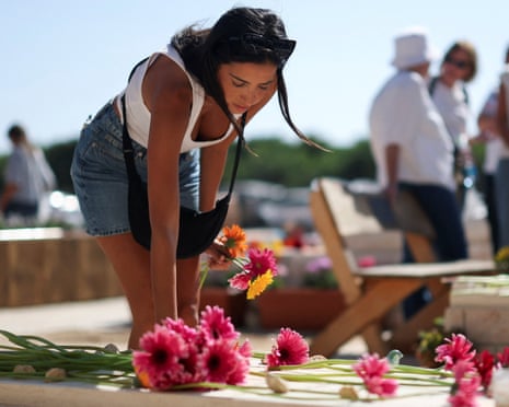 A woman reacts next to a grave as the community of kibbutz Kfar Aza commemorates their members who were killed, taken hostage and who died in captivity, after the deadly 7 October 2023 attack by Hamas, in kibbutz Kfar Aza, southern Israel, 16 October 2025.