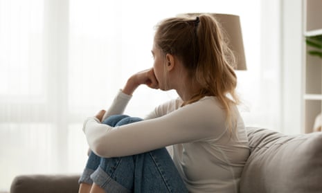 Woman on couch looking away from camera