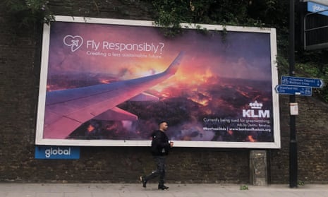 Poster with slogan 'fly responsibly' points out that KLM is being sued for greenwashing