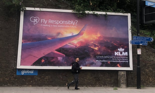 Poster with slogan 'fly responsibly' points out that KLM is being sued for greenwashing