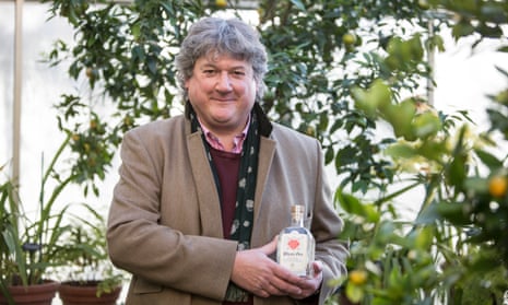 Professor Simon Hiscock, the director of the Oxford Botanic Garden, with a bottle of Physic Gin.