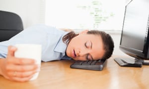 Sleeping woman in an office holding coffee