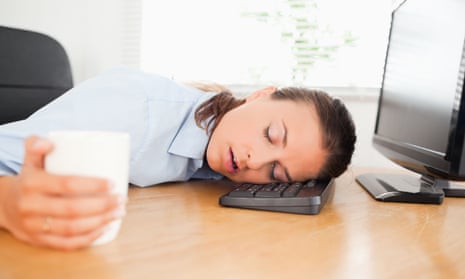 Sleeping woman in an office holding coffee