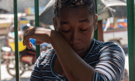 Madame Jesula Ville, seven months pregnant, recounts the murder of her husband, whose body was burned by armed gangs, in Port-au-Prince this week.