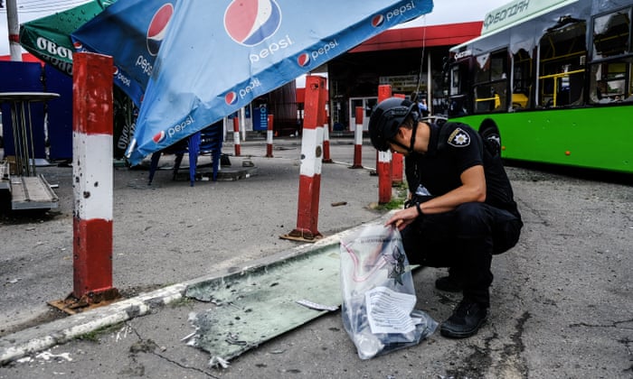 Security forces inspect the damaged area after this morning’s attack.